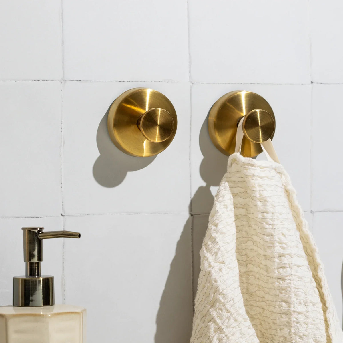 Gold Mountly towel hook in a bathroom